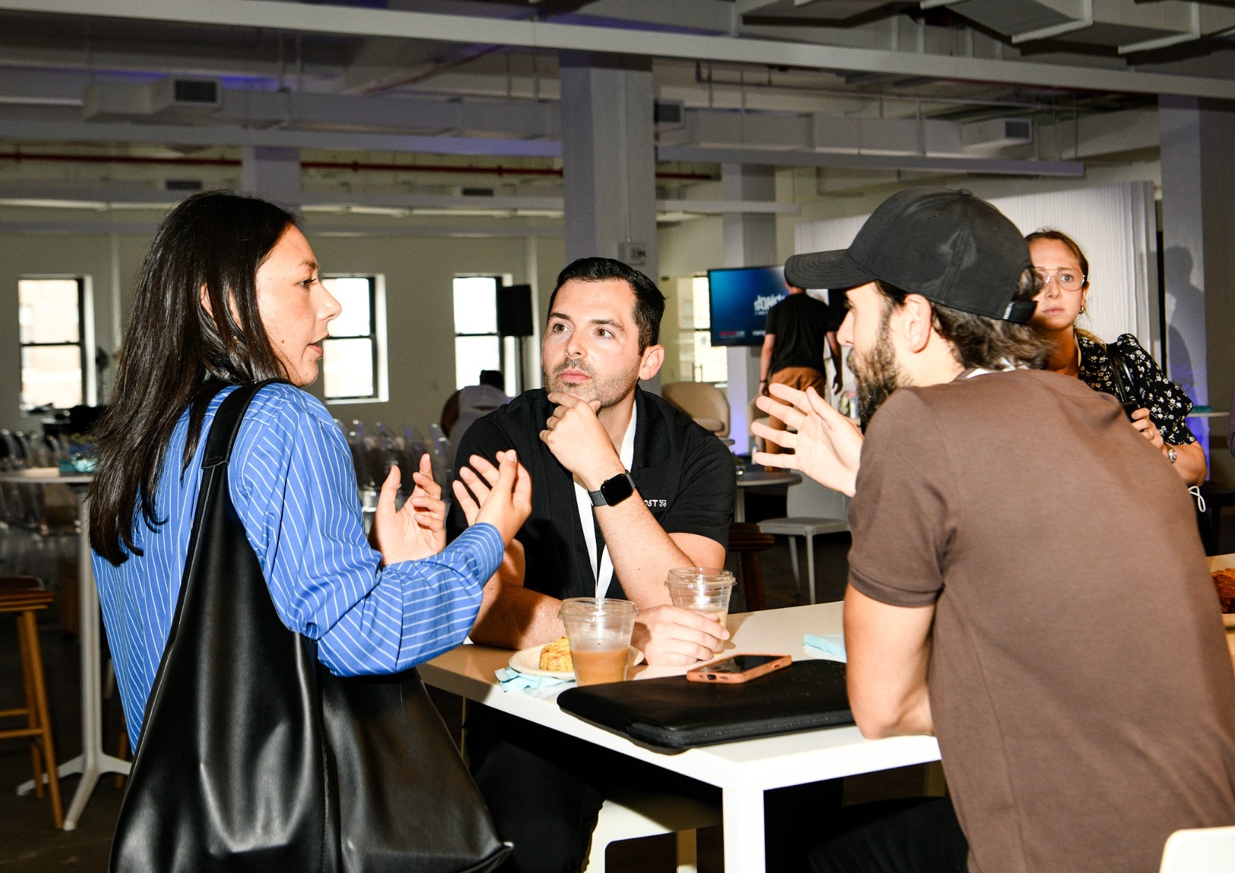 Inside Summit attendees talking around a table