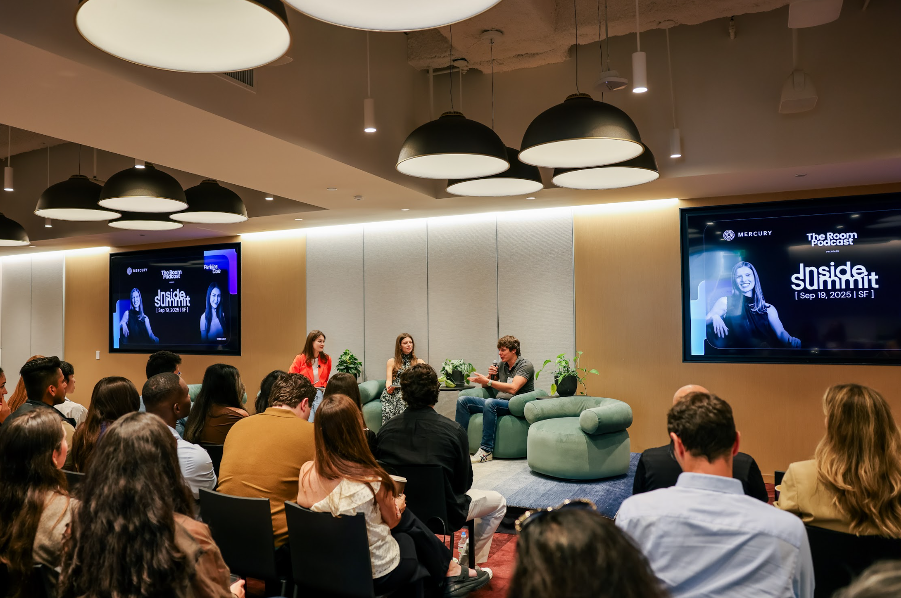 Speakers sharing a live conversation on stage at Inside Summit